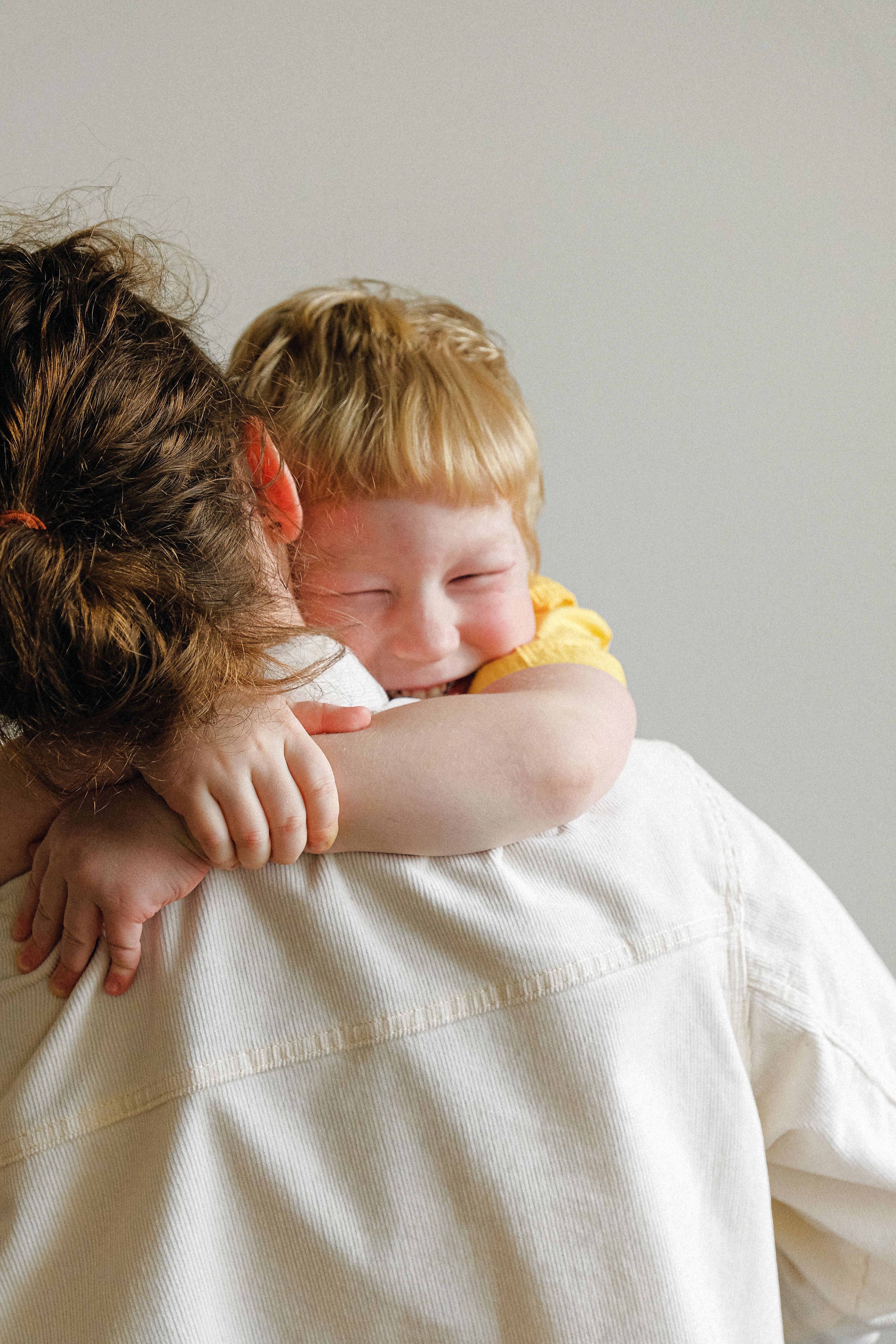 Mother hugging her smiling child